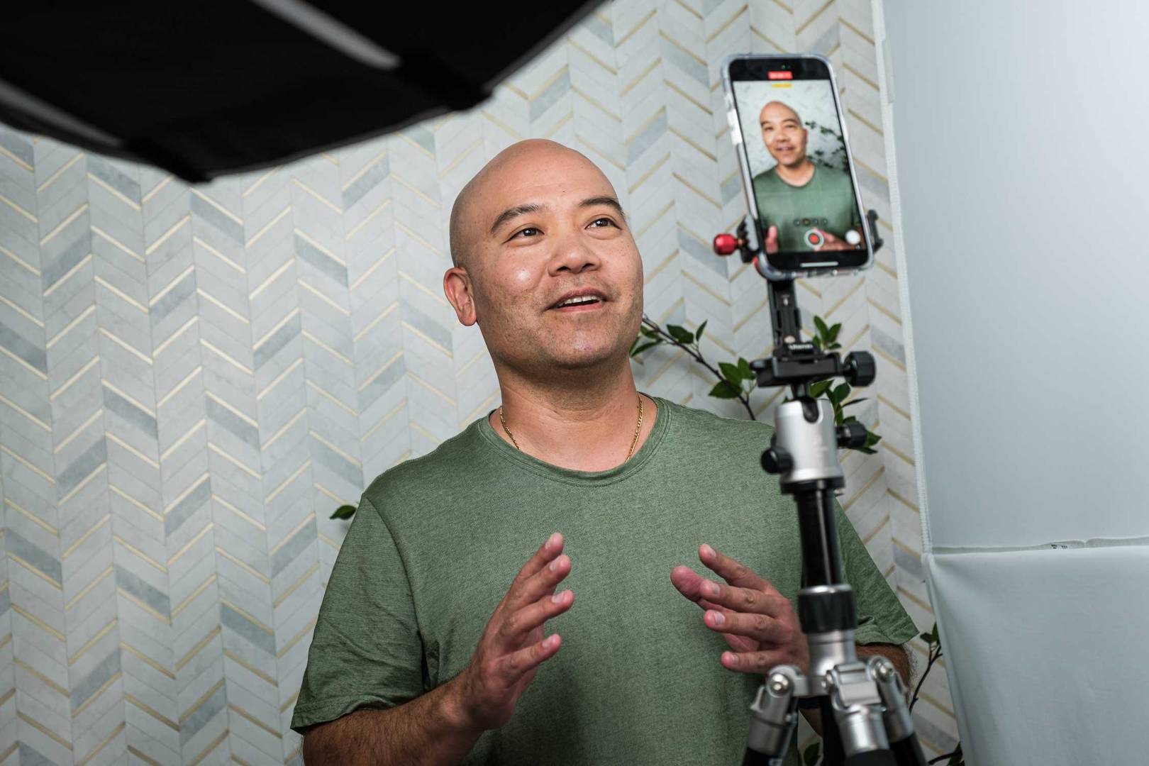 Clinical testing panelist recorded for a testimonial with a smartphone on a stand