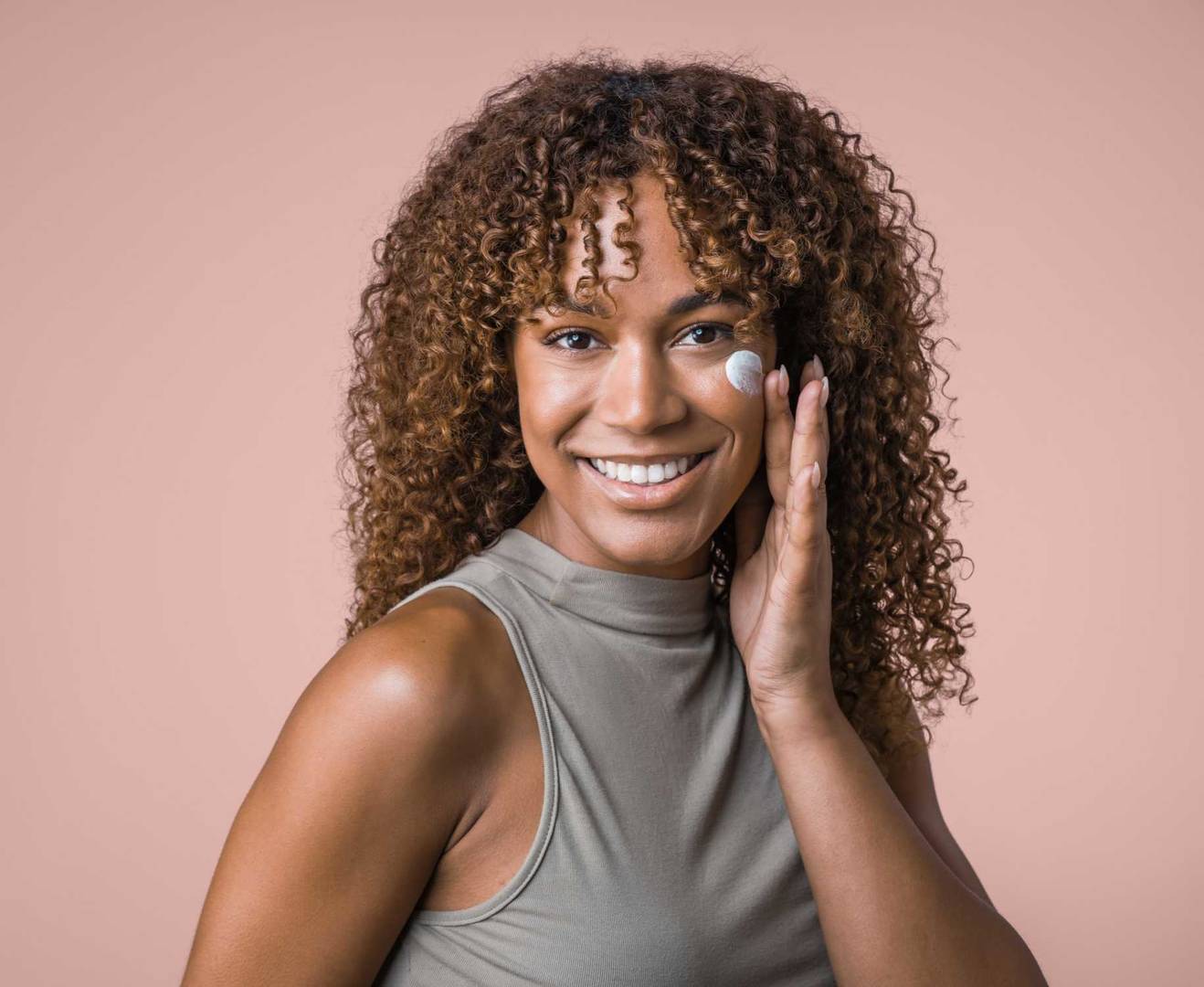 Clinical testing panelist posing with cosmetic cream on their face
