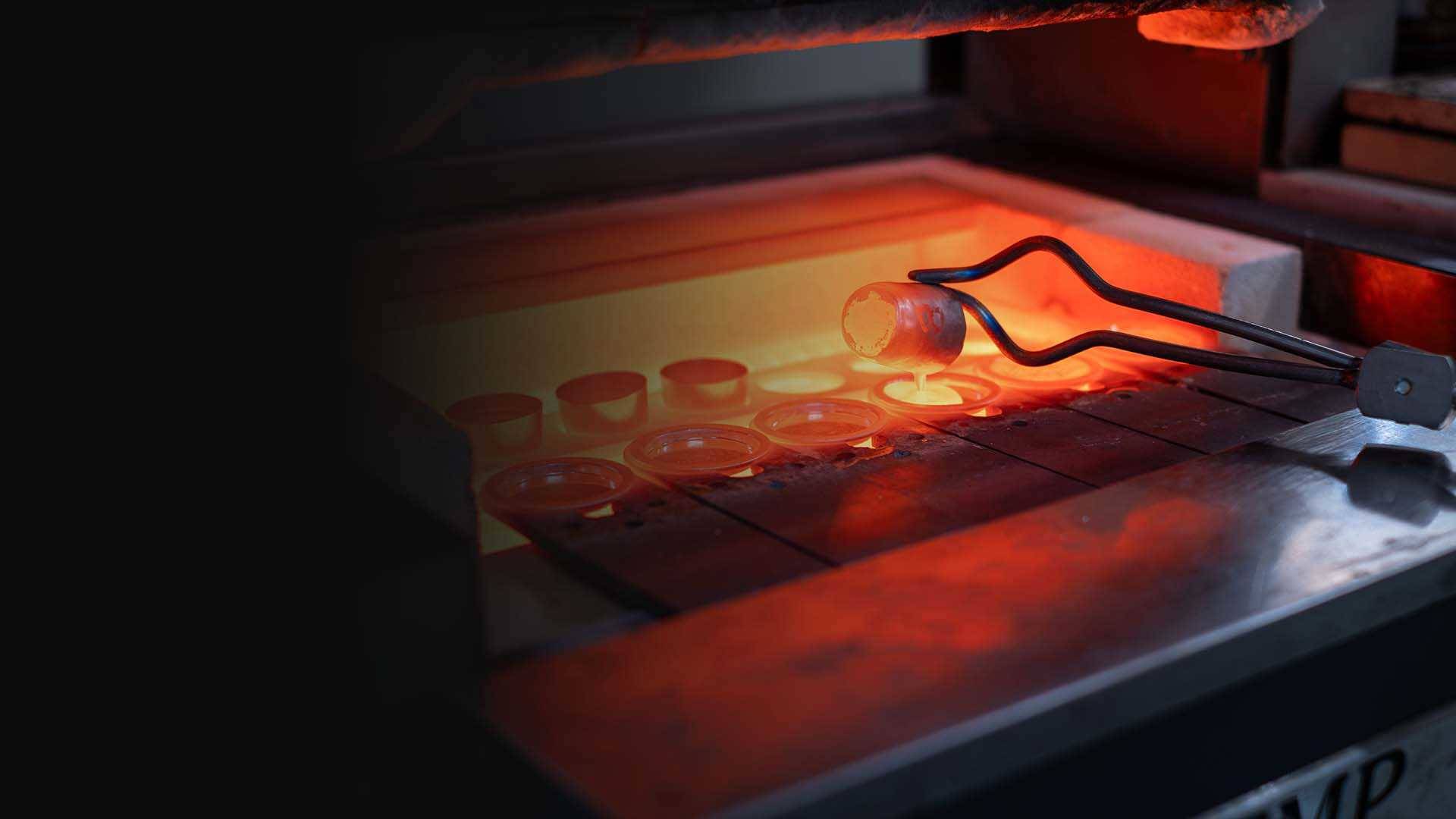 Tongs removing crucible from furnace in a Metallurgy laboratory