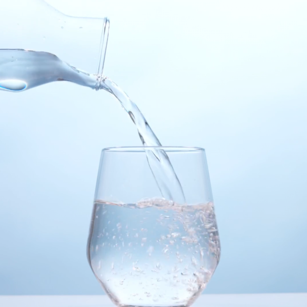Jug of water pouring into glass